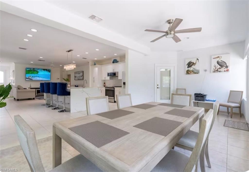 Dining space featuring light tile patterned flooring, recessed lighting, and a ceiling fan