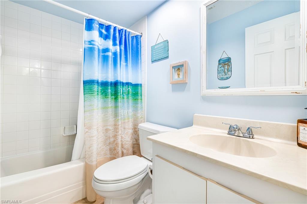 Bathroom with shower / bath combo and vanity