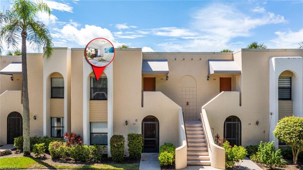 View of front of property with stucco siding and stairs