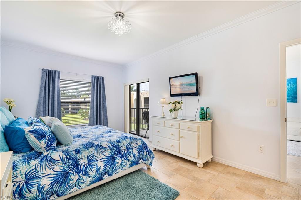 Bedroom featuring crown molding and access to exterior