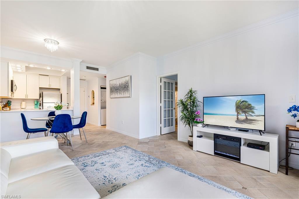 Living room featuring ornamental molding and baseboards