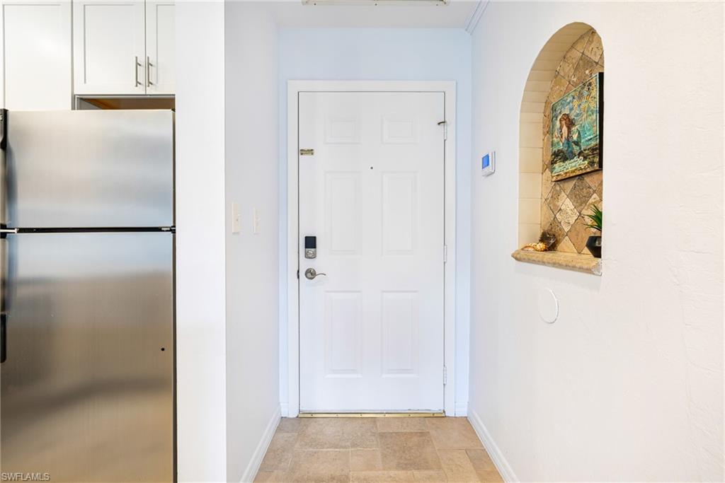 Doorway with baseboards and stone finish floors