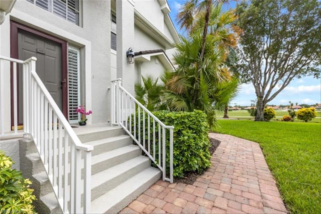 View of exterior entry featuring a yard