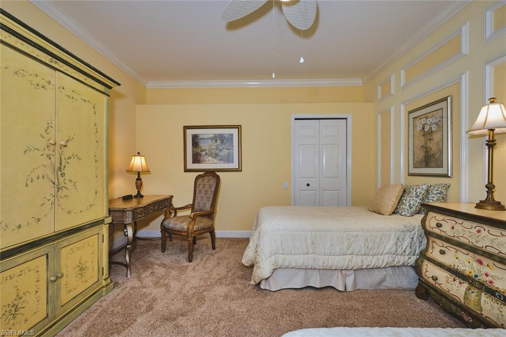 Bedroom featuring ornamental molding, light carpet, a closet, and ceiling fan