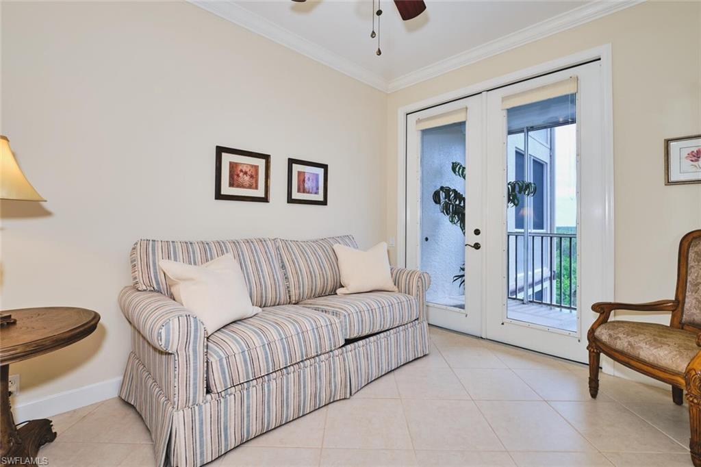 Living area featuring tile patterned flooring, ornamental molding, french doors, and ceiling fan