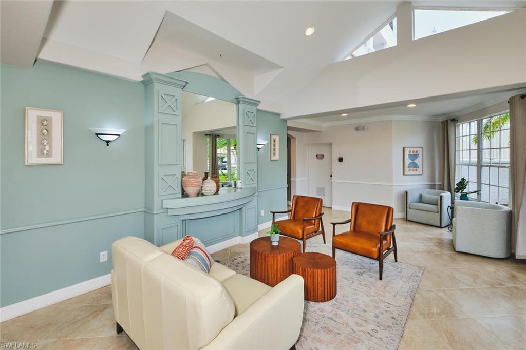 Sitting room featuring high vaulted ceiling, plenty of natural light, recessed lighting, light tile patterned floors, and ornamental molding