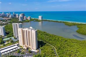 Birds eye view of property with a water view