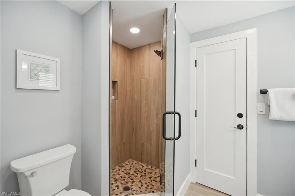 Bathroom featuring a stall shower, elevator, and recessed lighting