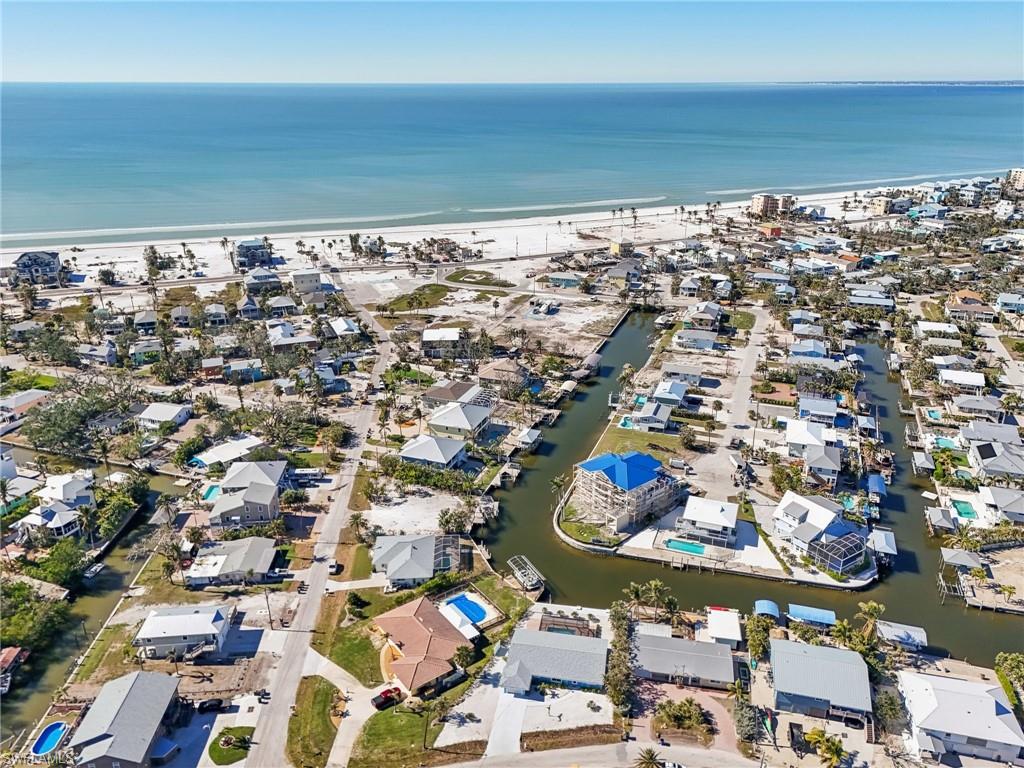 Aerial overview of property's location featuring a large body of water and nearby suburban area