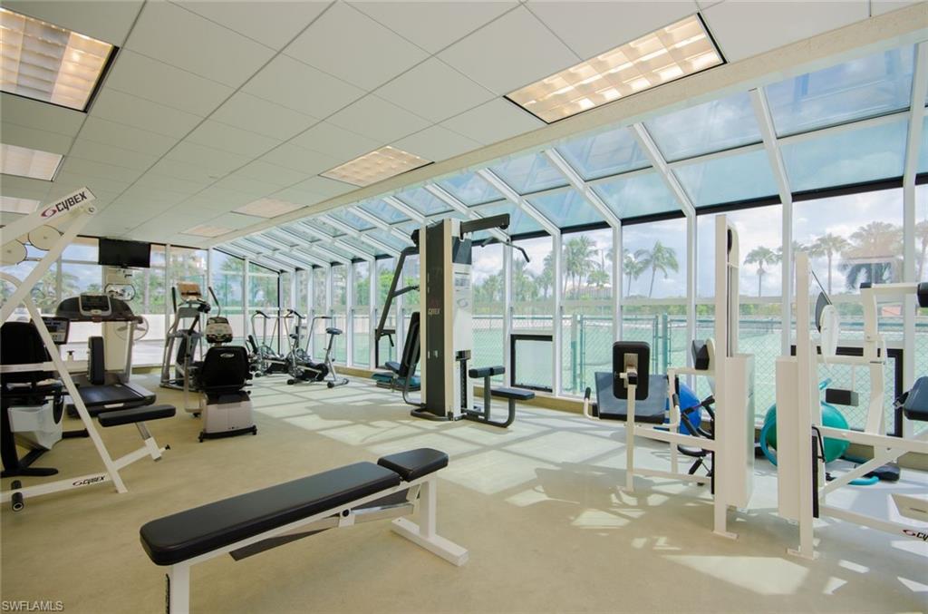 Gym featuring expansive windows and a drop ceiling