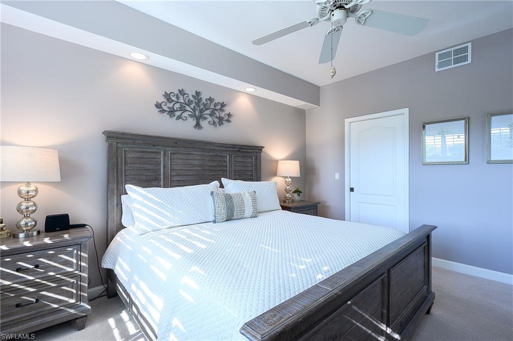 Carpeted bedroom with ceiling fan