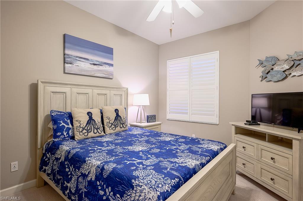 Bedroom featuring light carpet and ceiling fan