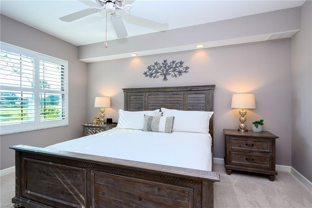 Carpeted bedroom with ceiling fan