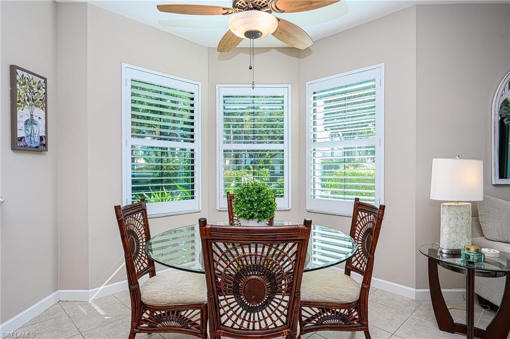 Tiled dining room featuring ceiling fan and plenty of natural light