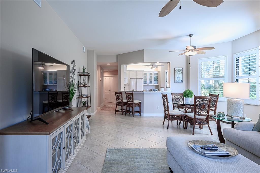 Living room with light tile patterned flooring and ceiling fan