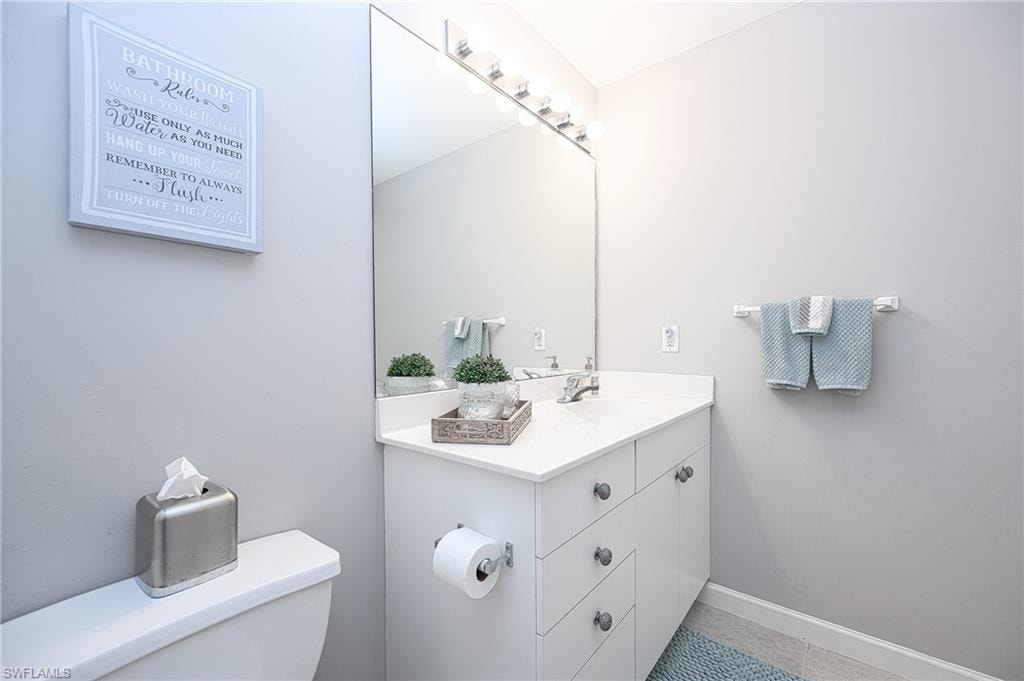 Bathroom with tile patterned flooring, vanity, and toilet