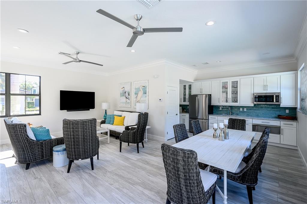 Dining area featuring light hardwood / wood-style flooring, crown molding, and sink