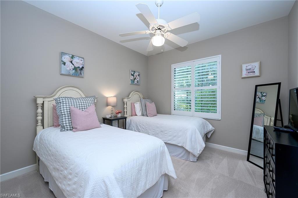 Bedroom featuring ceiling fan and light colored carpet