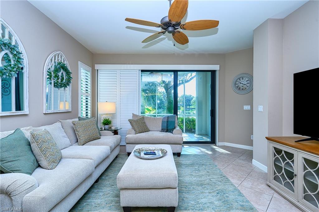 Living room featuring ceiling fan and light tile patterned floors