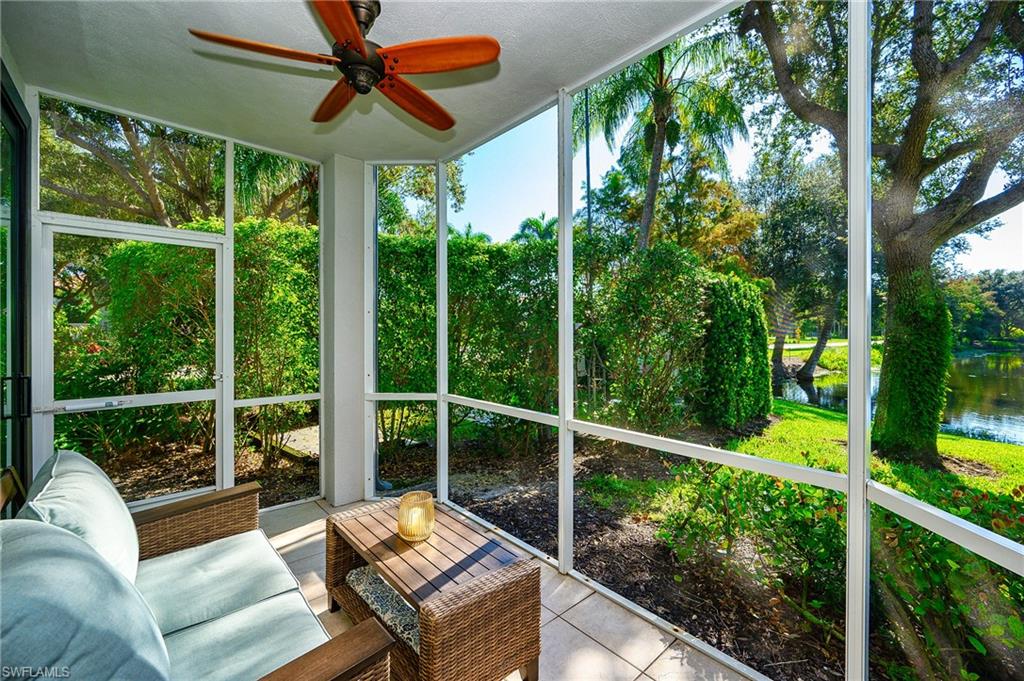 Sunroom / solarium featuring ceiling fan, plenty of natural light, and a water view