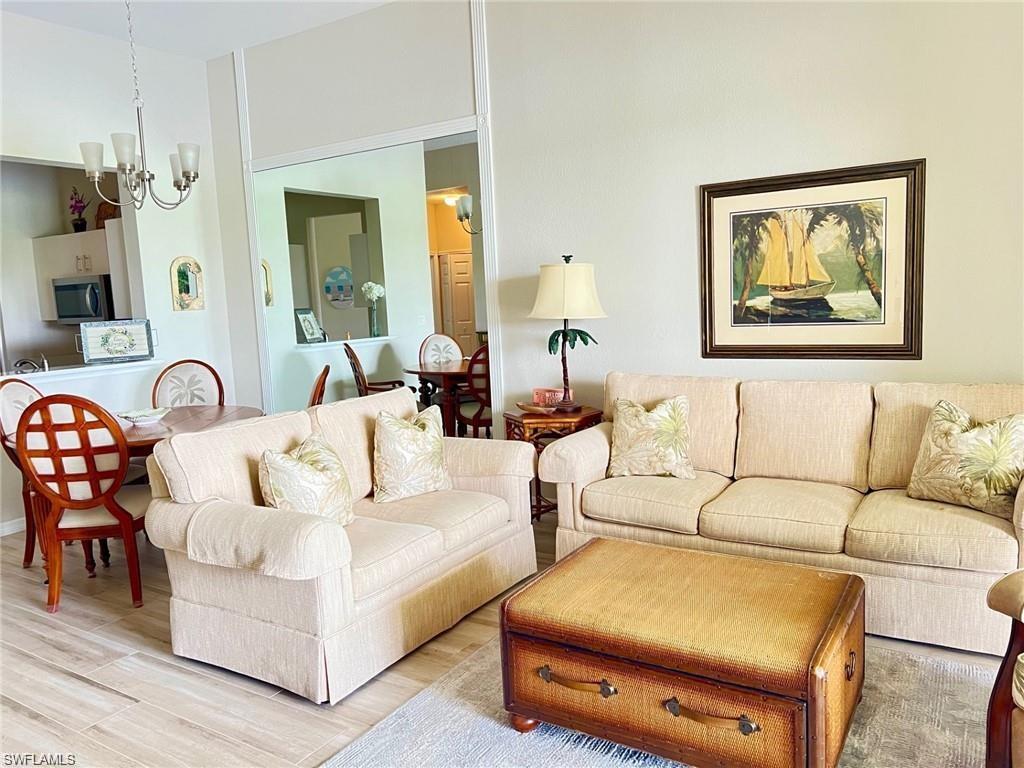Living area featuring wood finished floors and a chandelier