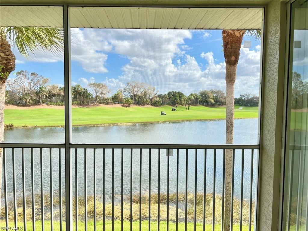 Water view featuring a tree filled landscape and a golf club