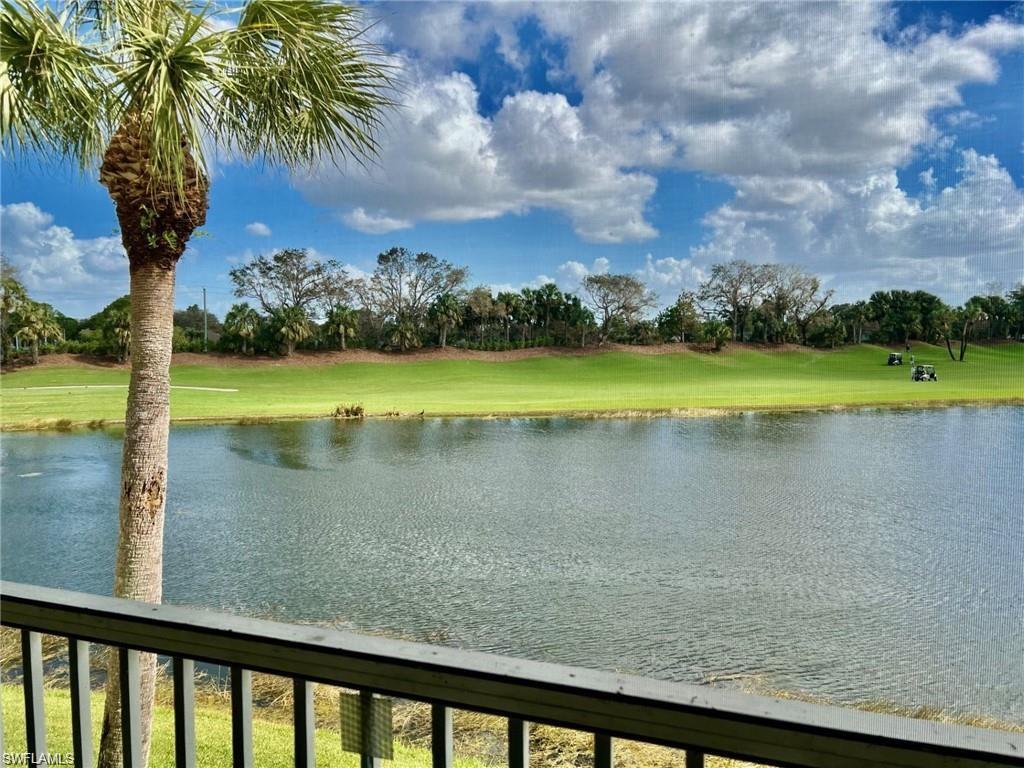 Water view with a tree filled landscape and a golf course