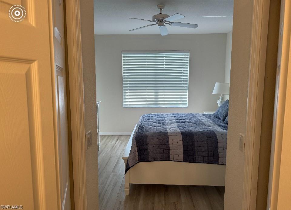 Bedroom with wood finished floors and a ceiling fan