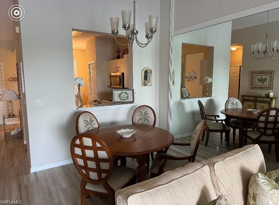 Dining area with a chandelier and wood finished floors