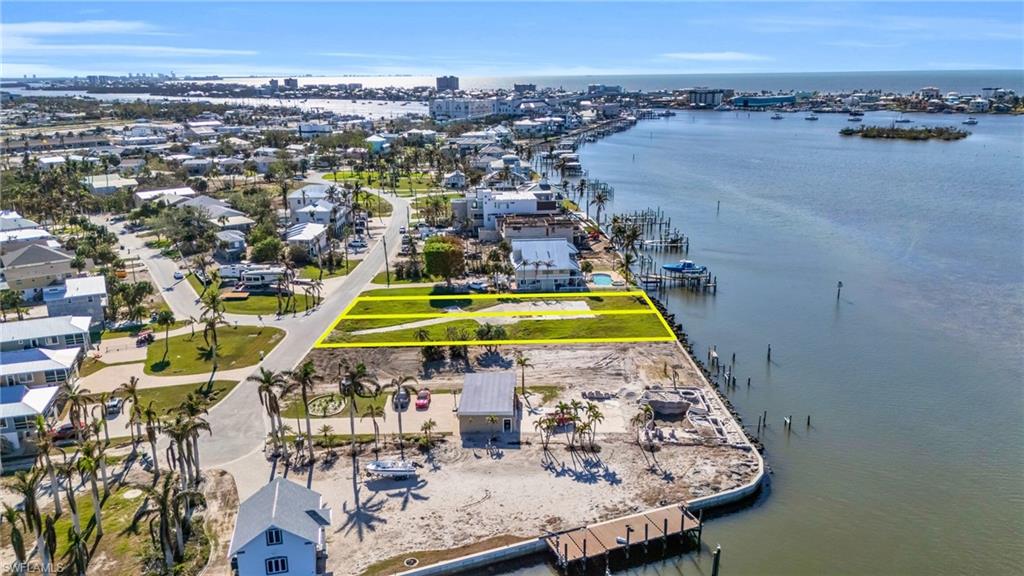 View of property location with a large body of water and property parcel outlined - Virtually Edited Image
