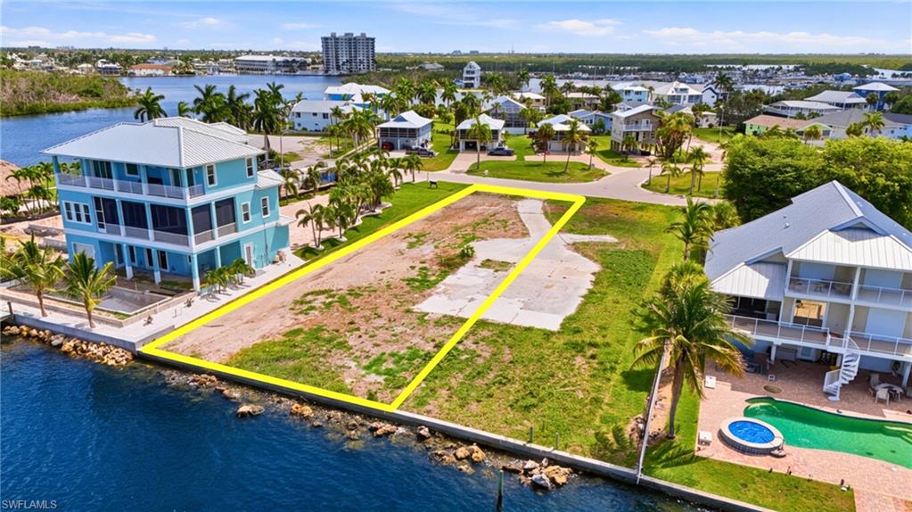 Waterfront lot featuring a concrete driveway and direct water access- Virtually Edited Image