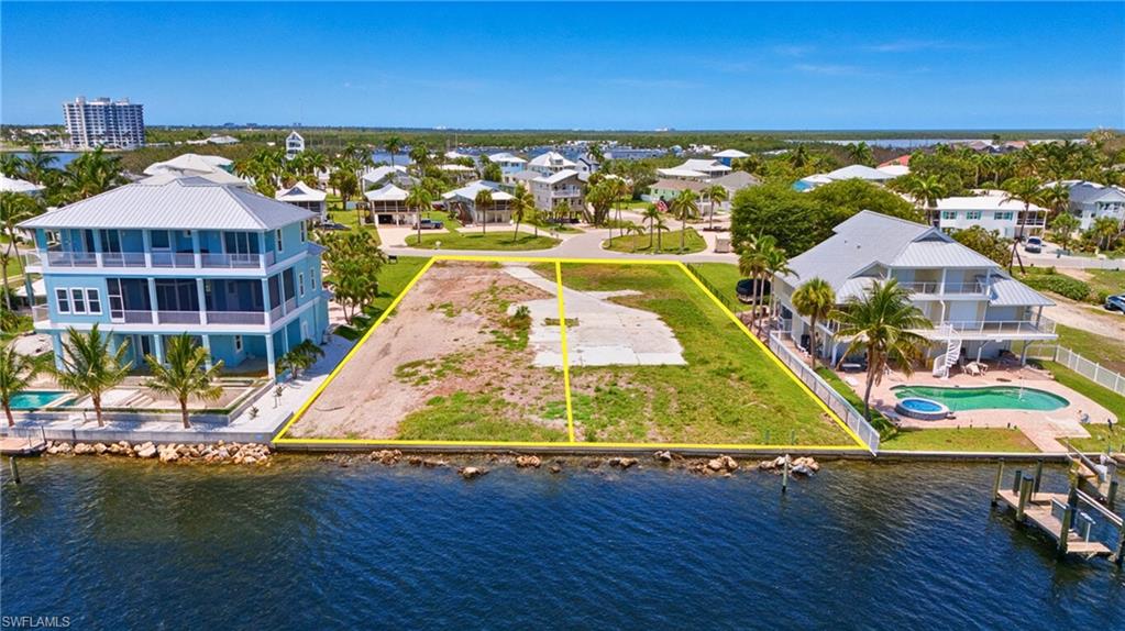 Waterfront lot featuring a partially cleared building site and direct water access - Virtually Edited Image