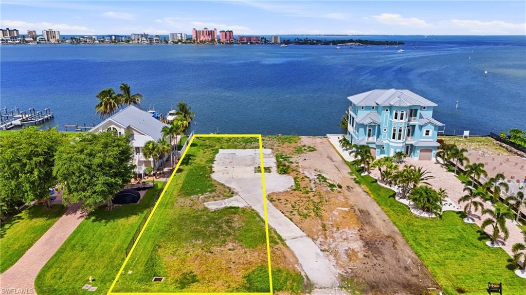Waterfront lot with established curb cut and concrete pad - Virtually Edited Image