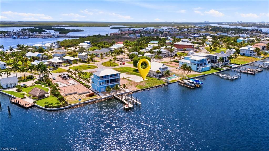 Waterfront property featuring direct canal access, an established community, and a clear building site - Virtually Edited Image