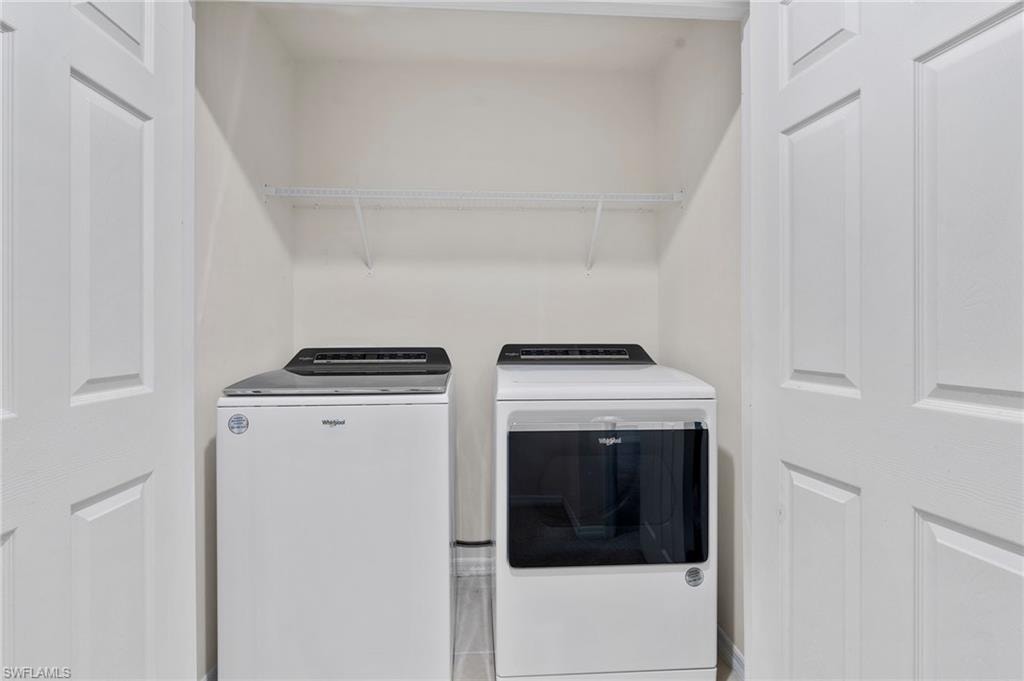 Laundry area with washing machine and clothes dryer