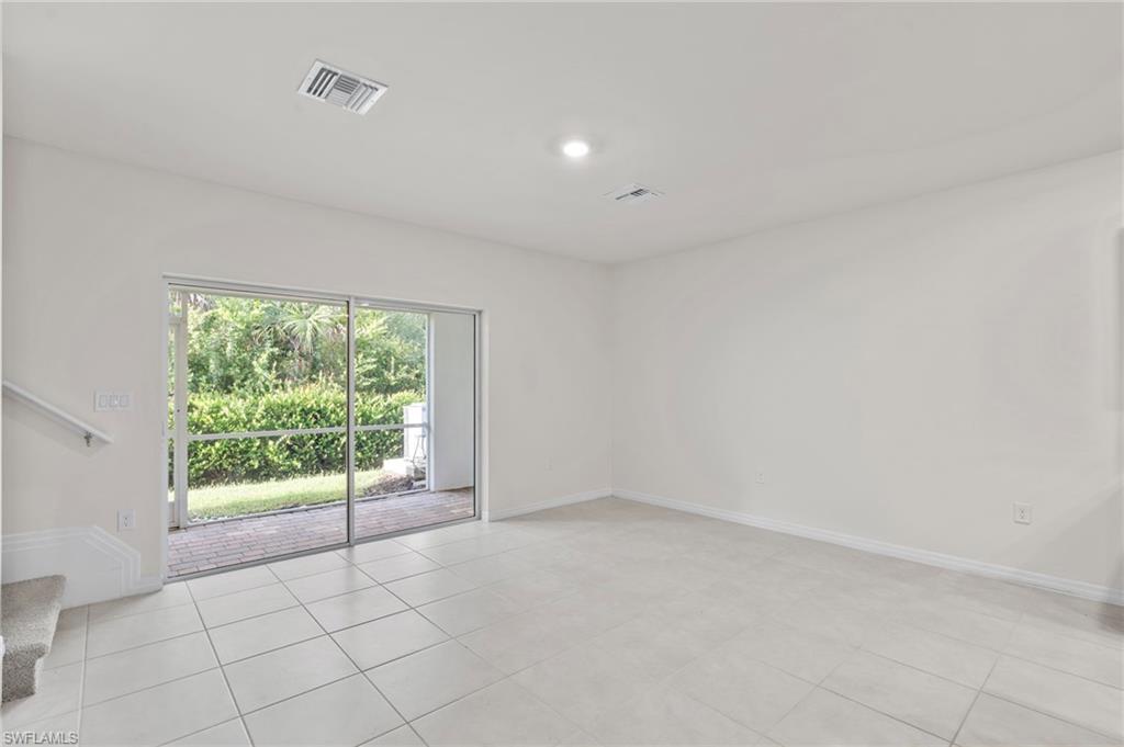 Unfurnished room with stairway, light tile patterned floors, and recessed lighting