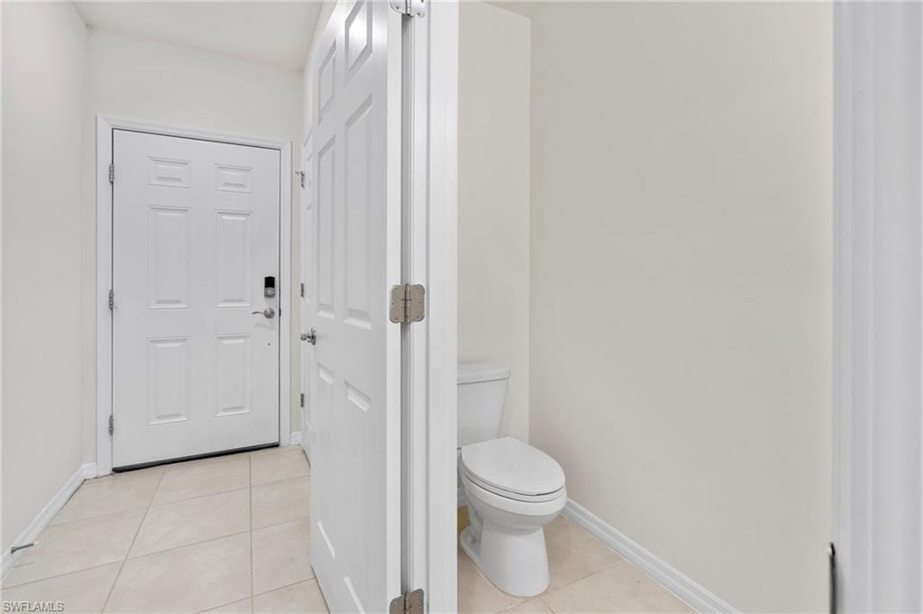Bathroom featuring light tile patterned floors and baseboards