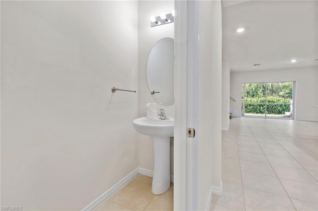 Bathroom featuring light tile patterned flooring and recessed lighting
