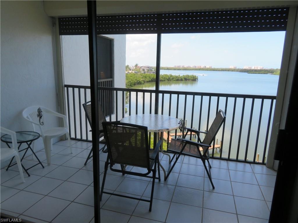 Balcony with a water view and a sunroom