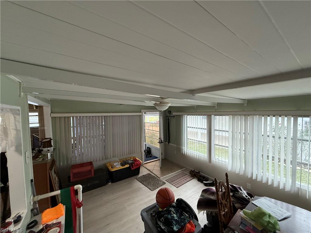 Sunroom / solarium featuring beamed ceiling