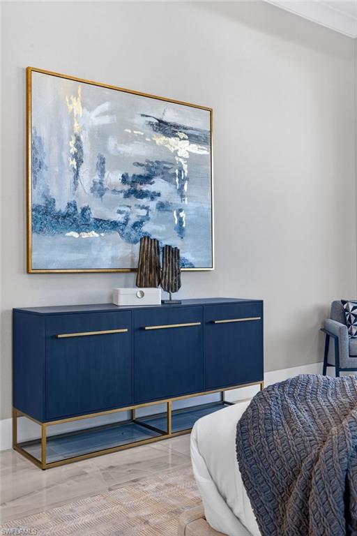 Bedroom with light wood-style floors and baseboards