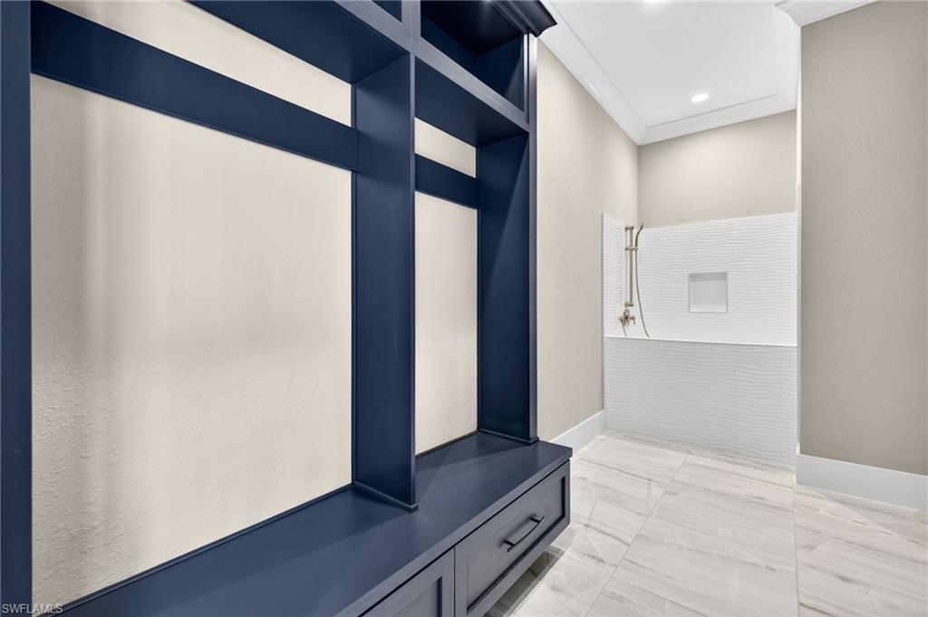 Mudroom with light marble finish floors and baseboards