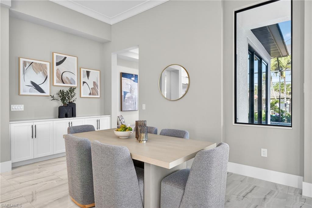Dining room featuring crown molding and baseboards