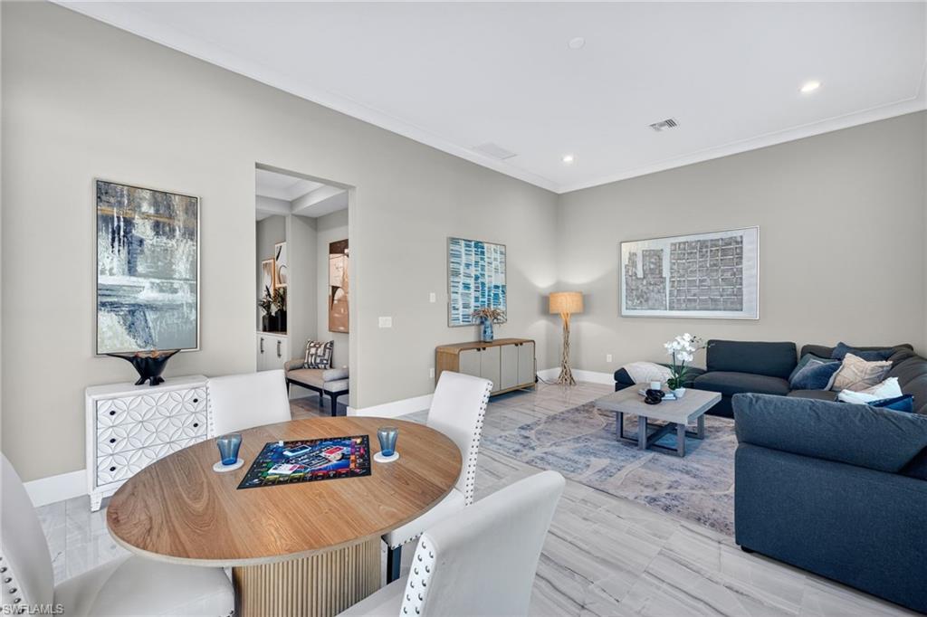 Dining space with recessed lighting, ornamental molding, and wood finished floors