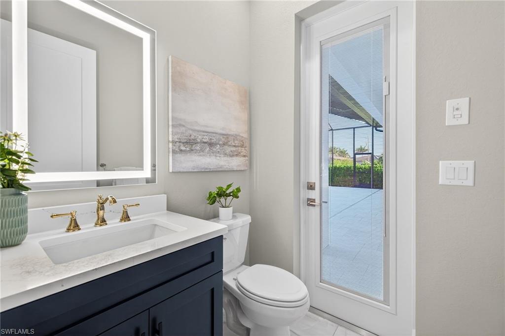 Half bathroom with vanity and toilet