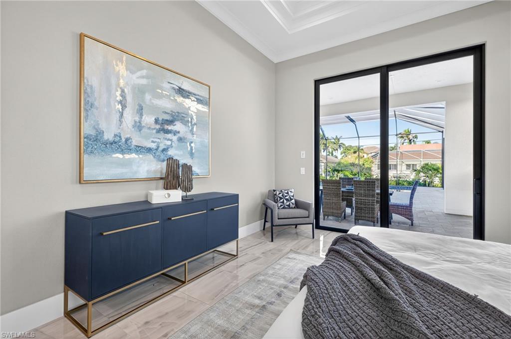 Bedroom with crown molding and access to exterior