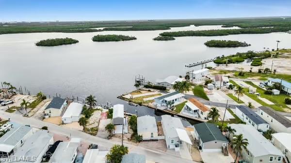 Aerial view of residential area featuring a nearby body of water