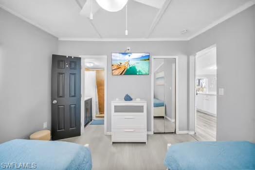 Bedroom with attic access, a closet, and light wood finished floors