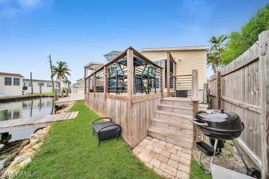 Rear view of house with a deck and a yard
