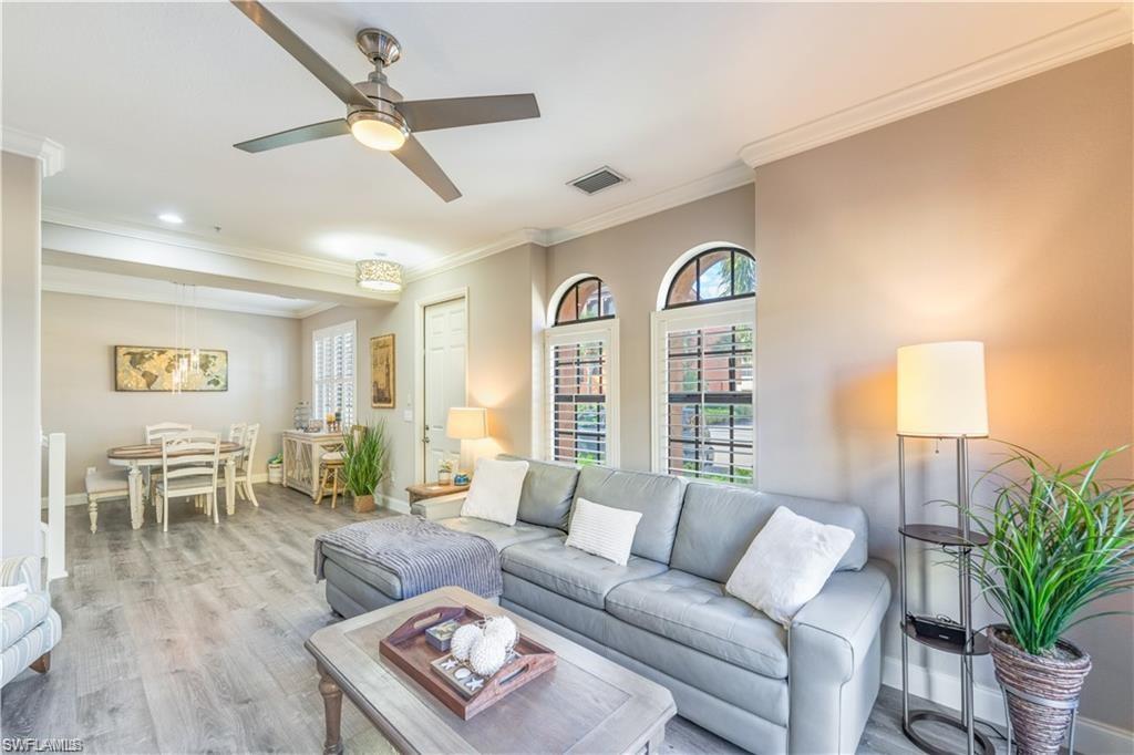 Living room featuring ornamental molding, wood finished floors, and ceiling fan